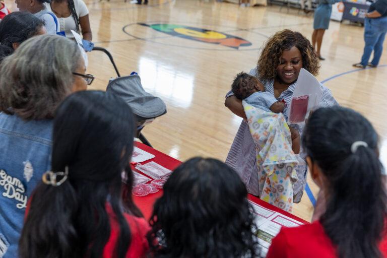 A mother accepts a raffle prize