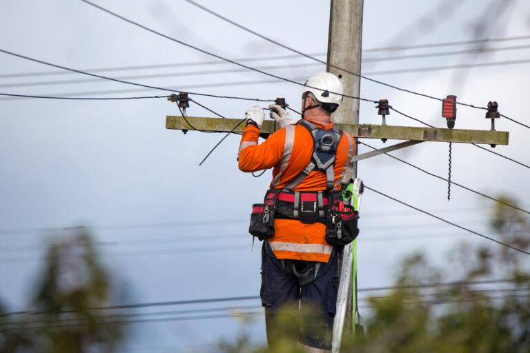 A linesman with a power company working on a powerline