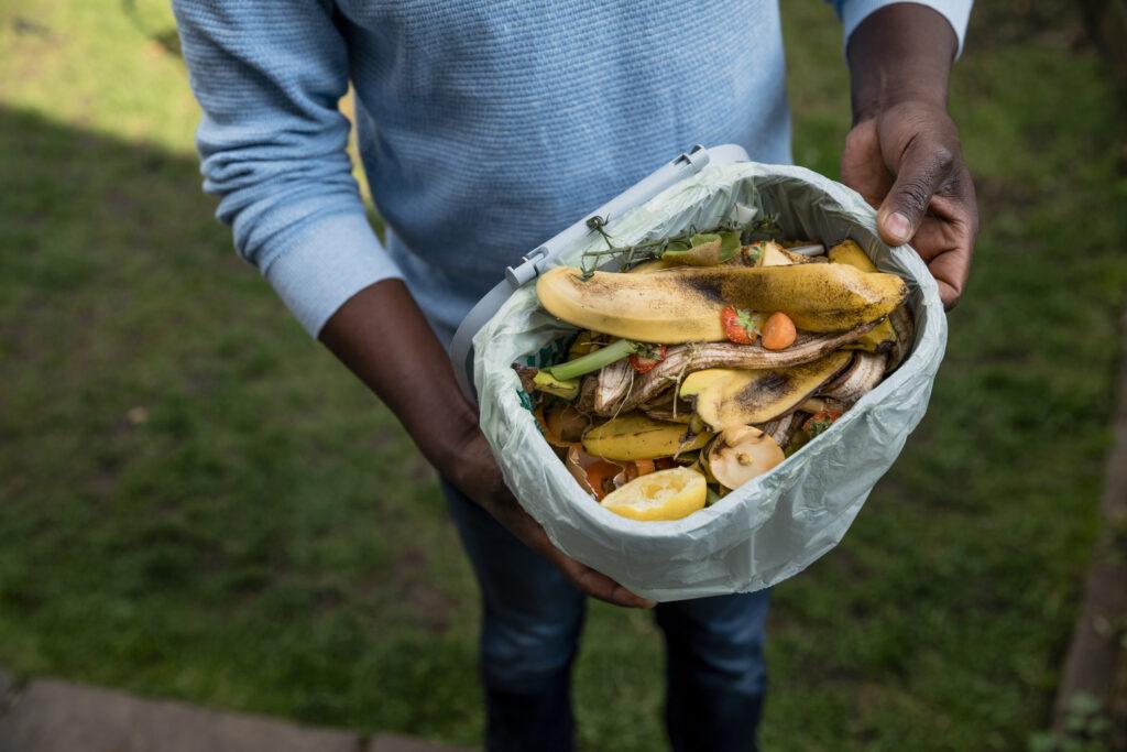 Man composting in his backyard