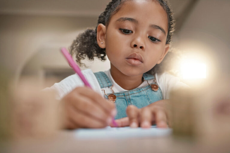 Child learning to write in cursive writing