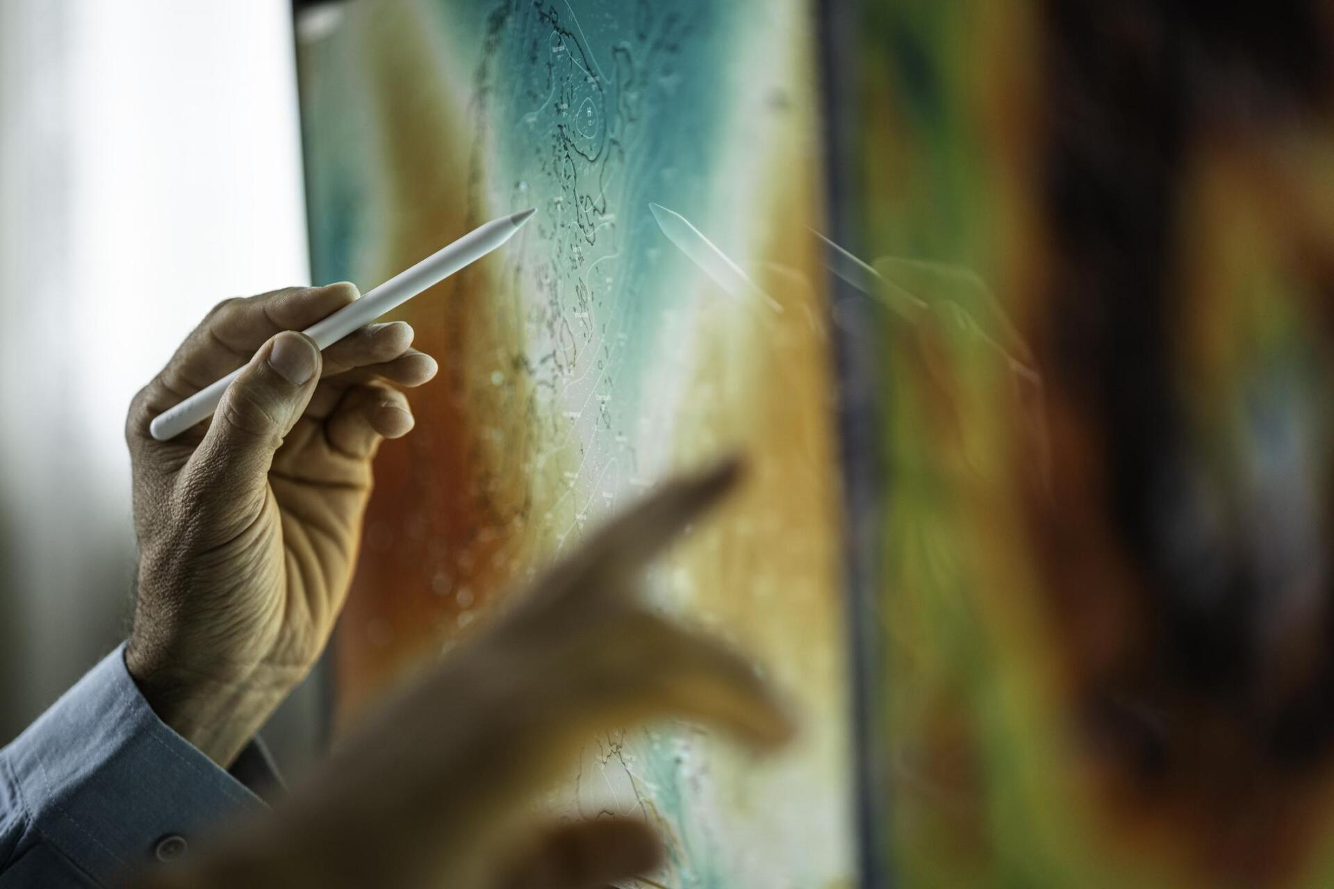 Hands using tech for monitoring weather conditions in logistics center