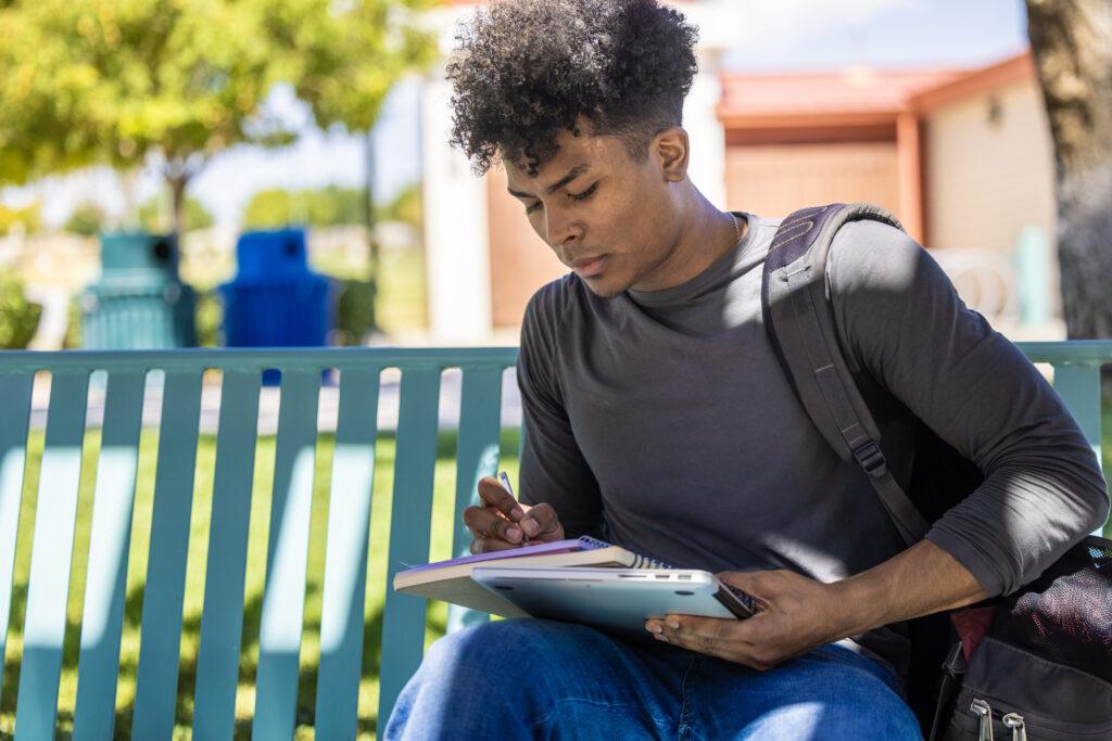 Student working on a school bench