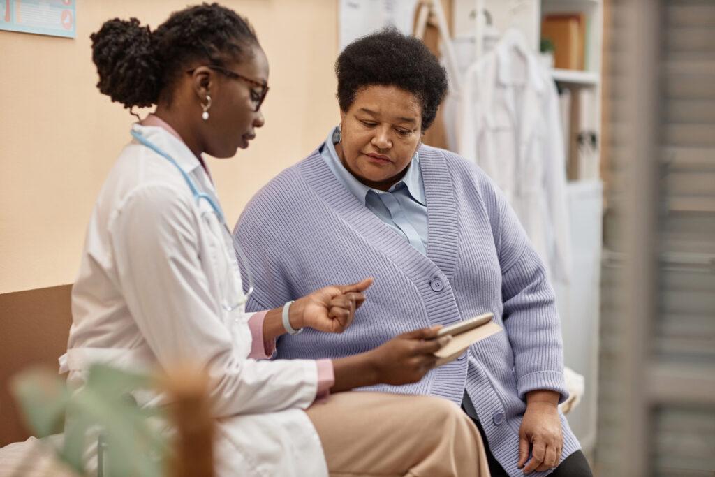 Doctor speaking with patient and going over chart