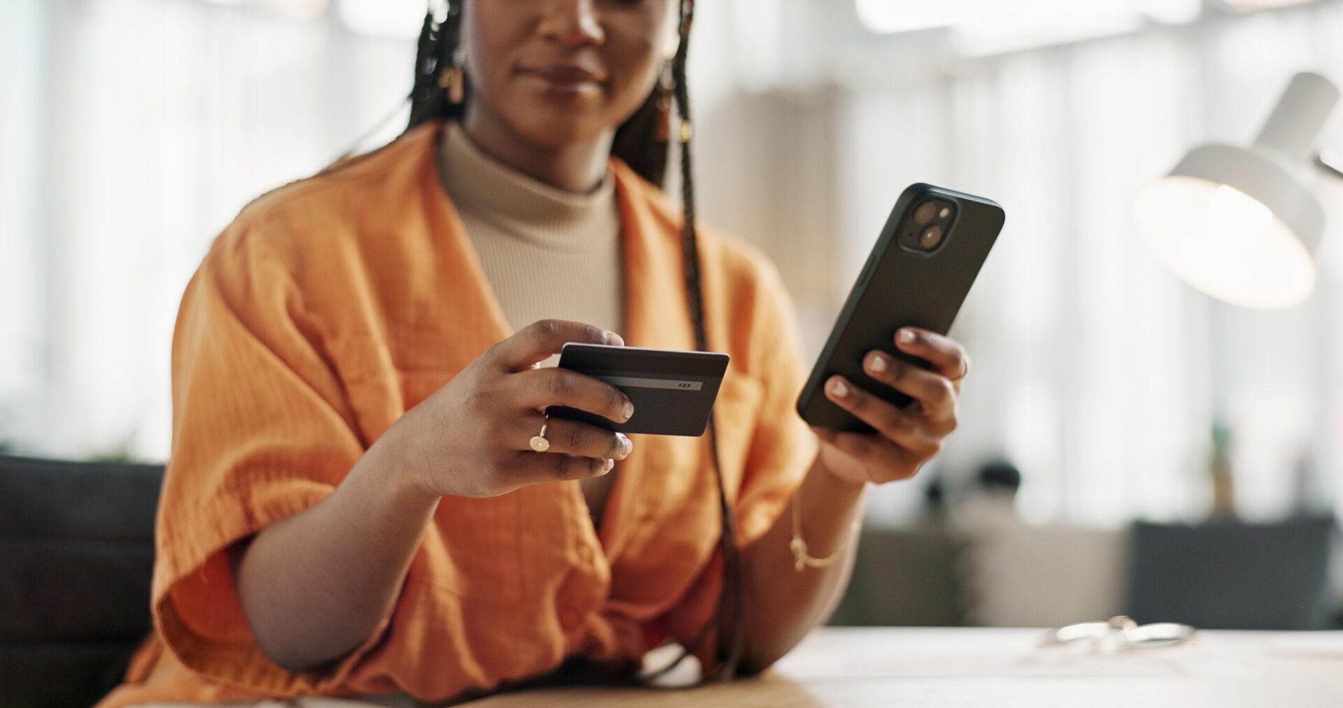 Woman paying with credit card over the phone.
