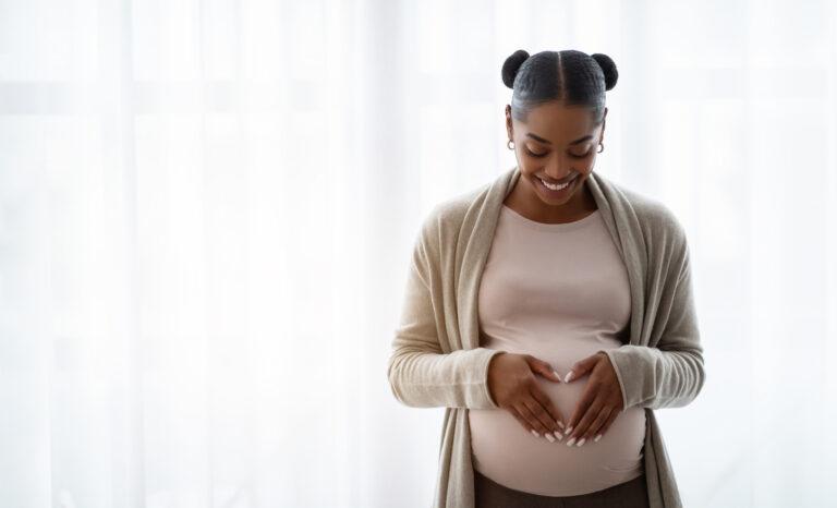 Smiling pregnant black woman
