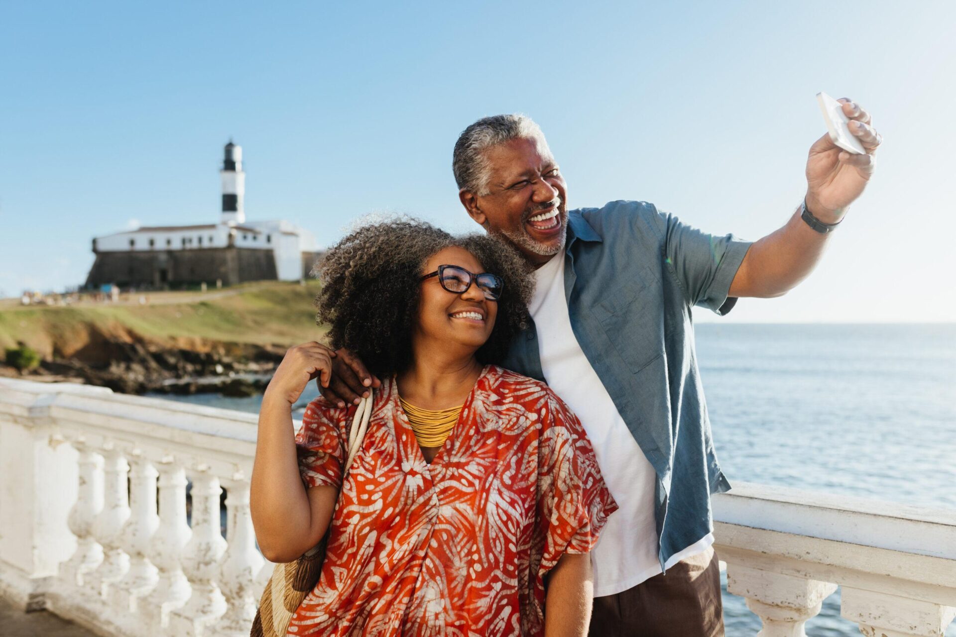 Retired couple taking a photo on vacation