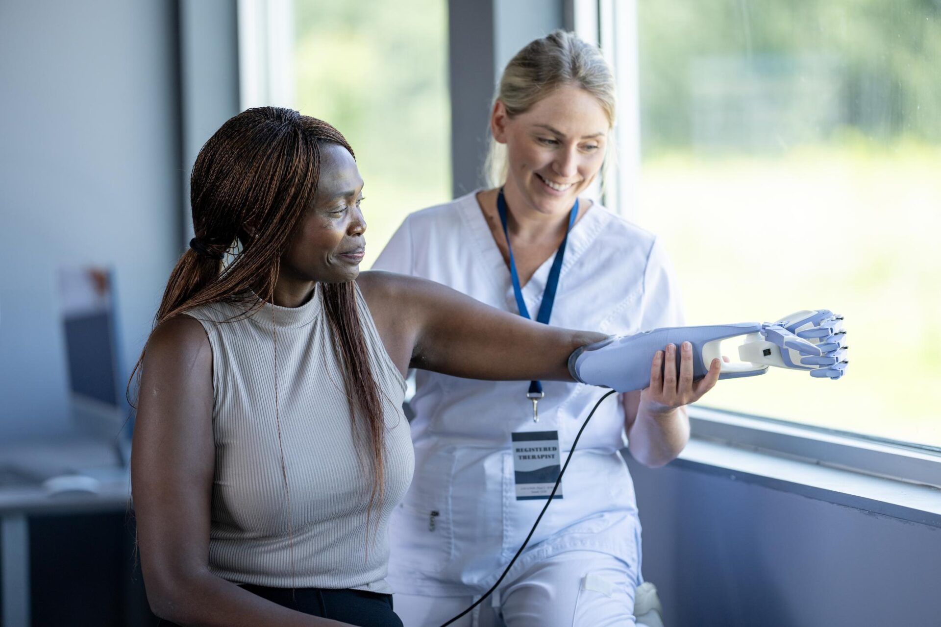 Woman with prosthetic arm and doctor