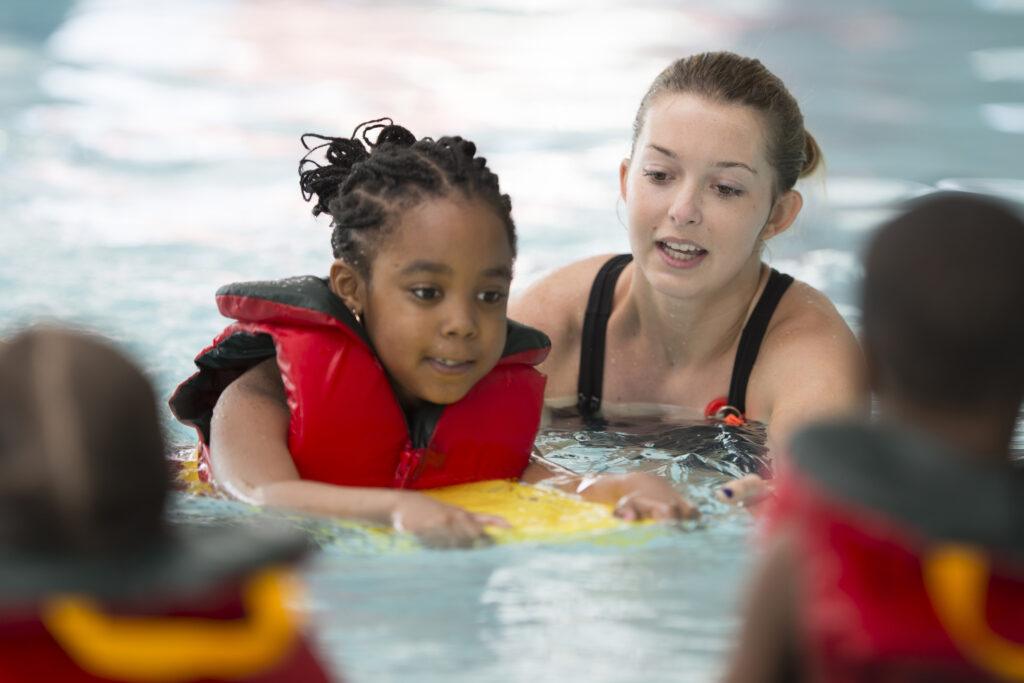 Young child taking a swimming class