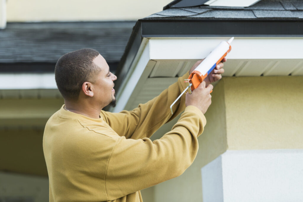 Young man working on his roof. 