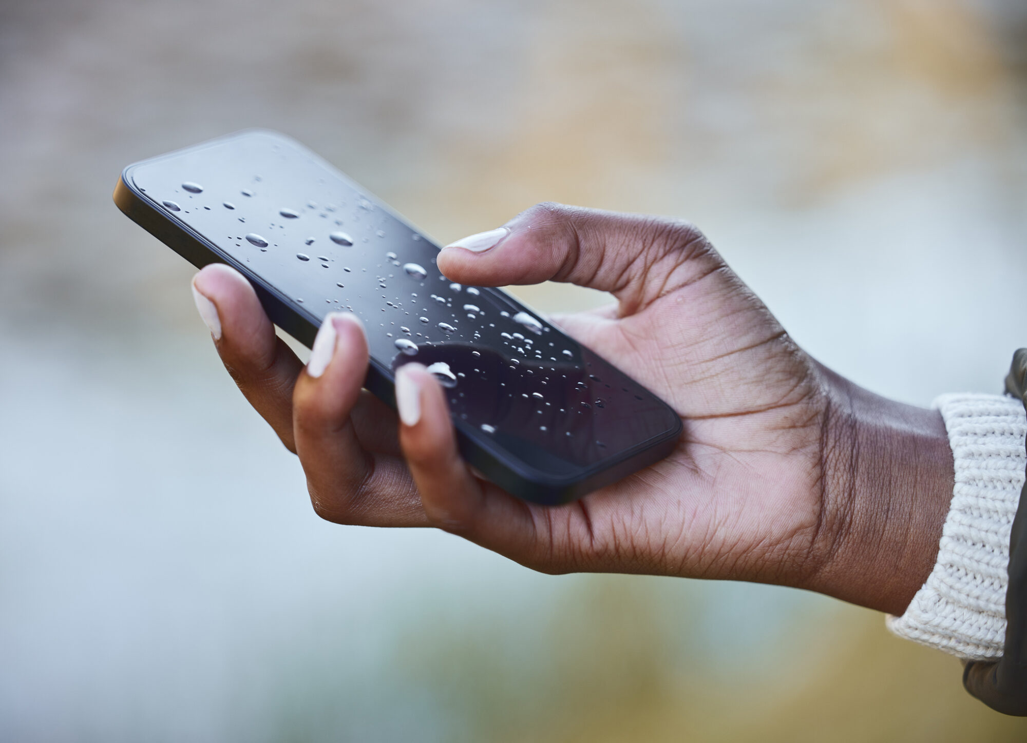 Hand holding a wet phone