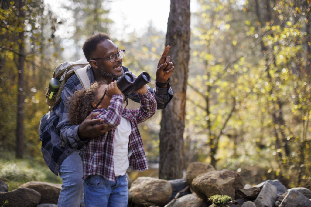 Father and daughter hiking in forest